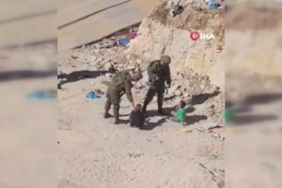 İsrail askerleri iki çocuğu yerlerde sürükledi
